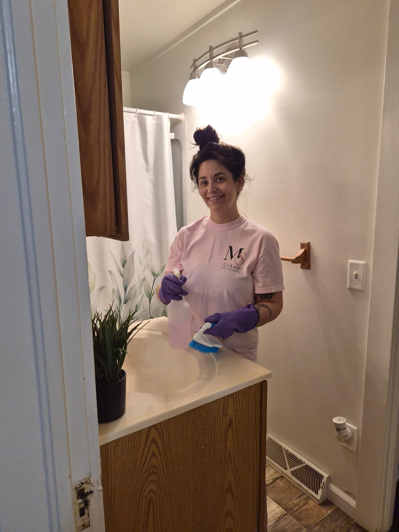 Maegan Schultz cleaning a bathroom for MS Clean Solutions